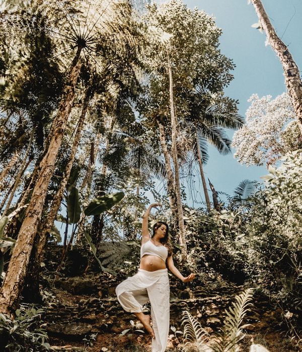 Woman performing a flowing yoga pose in a calm environment.